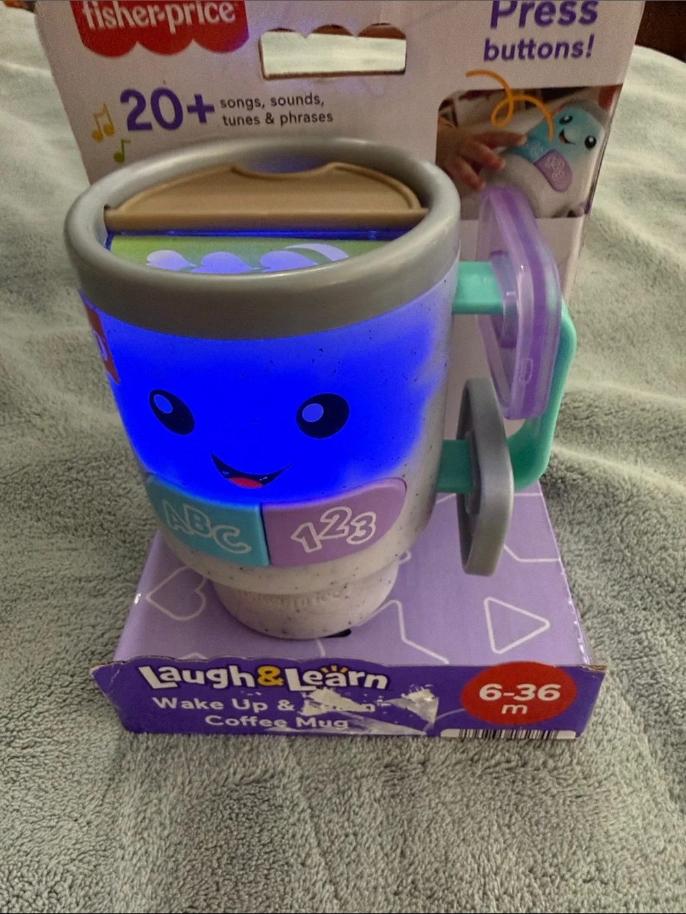 Fisher-Price Laugh & Learn Light-Up Learning Mug in Blue, Purple, Teal, Gray